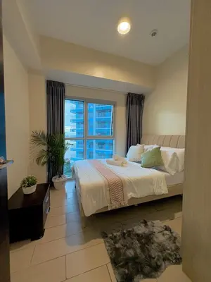 a bedroom with a bed and a large window at 2BR at Bayshore 2 Near Okada & Airport in Manila