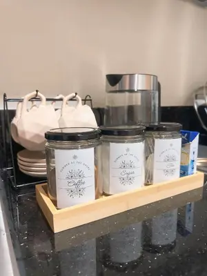 a shelf with three jars and a coffee pot on it at Summer At The Shore in Manila