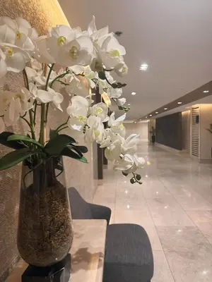 a vase with white flowers in a lobby at Summer At The Shore in Manila