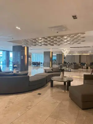 a lobby with couches and tables in a building at Summer At The Shore in Manila