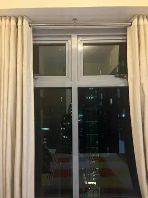a window with a view of a city at 1 BR Unit at Park West - BGC in Manila