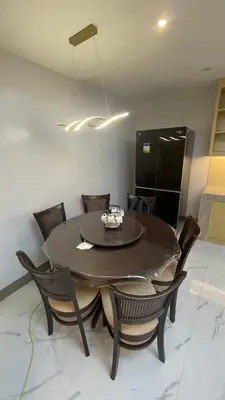 a dining room with a black table and chairs at Silang Guest house