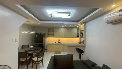 a living room with a kitchen and a dining room at Silang Guest house