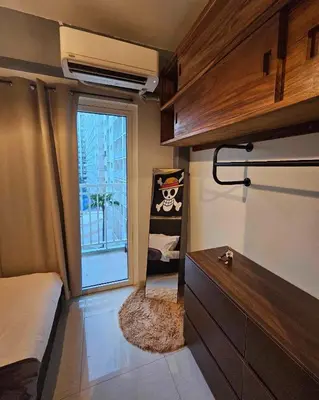 a bedroom with a bed and a window and a dresser at Grand Line Hideout in Manila