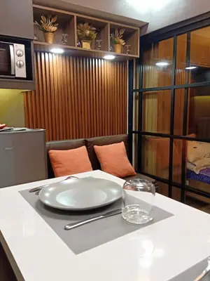 a table with a white plate on top of it at Fully Furnished Condo Near BGC in Manila
