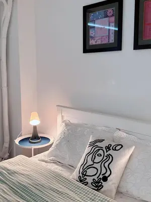 a bedroom with a bed with a pillow and a lamp at Place to stay in pasay near Airport in Manila