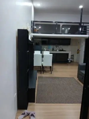a kitchen and living room with a table and chairs at Stayover Transient House in Carmen