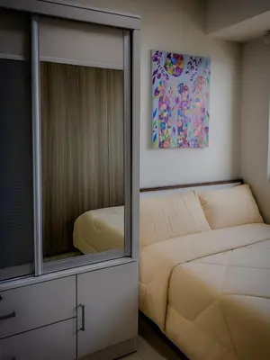 a bedroom with a bed and a mirror at The Bat Cave 3 at Coast Residences Pasay in Manila