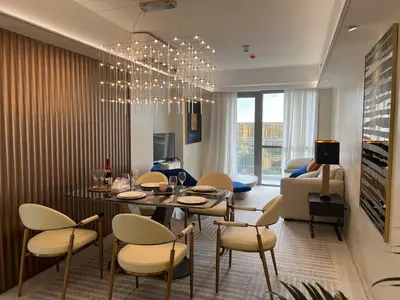 a dining room and living room with a table and chairs at Modern Boutique Spacious Apartment Near Airport OKADA SOLAIRE MOA in Manila