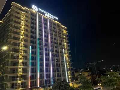 a building with a sign on top of it at night at Modern Boutique Spacious Apartment Near Airport OKADA SOLAIRE MOA in Manila