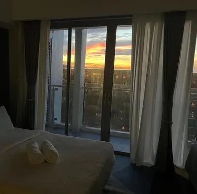 a hotel room with a bed and a large window at Modern Boutique Spacious Apartment Near Airport OKADA SOLAIRE MOA in Manila