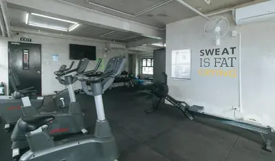a gym with two tread machines in a room at RedDoorz Premium at MyTown New York in Manila