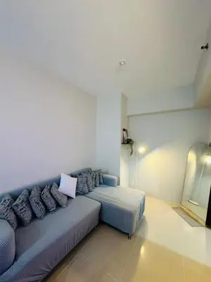 a living room with a couch in a room at 6G Manor in Manila