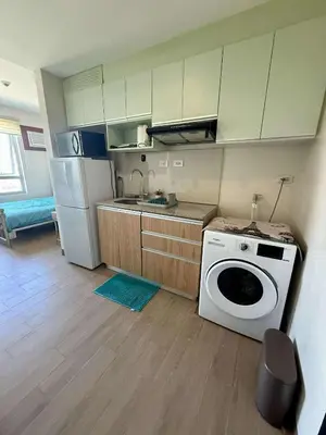 a kitchen with a washing machine and a refrigerator at The Cozy Rustic in General Trias