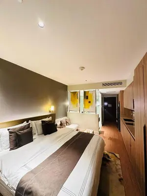 a bedroom with a large bed in a room at RBR LUX at Novotel Manila Hotel Residences Acqua in Manila