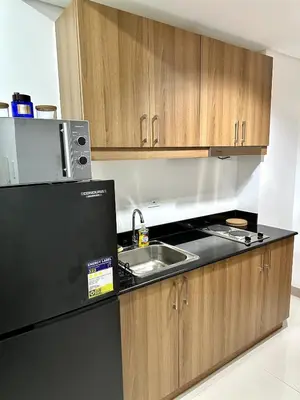 a kitchen with a sink and a microwave at City SkyView - Level 24 - Pool - Lush Residences in Manila