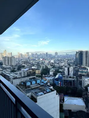 a view of a city from a balcony at City SkyView - Level 24 - Pool - Lush Residences in Manila