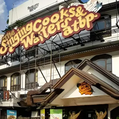 a sign for a restaurant on the side of a building at Relax in Comfort at Shore 2 Residences Mall of Asia-Pasay in Manila