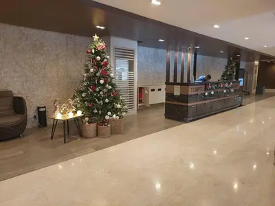 a christmas tree in the middle of a lobby at StaycationPH in Manila