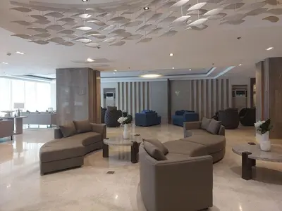 a lobby with couches and tables in a building at StaycationPH in Manila