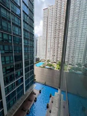 a view of a pool from a building with tall buildings at 1BR - Uptown BGC Taguig in Manila