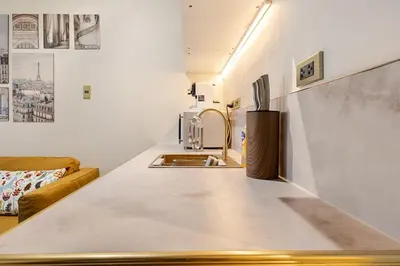 a kitchen with a counter top with a sink at Opulent Condo Knightsbridge Residences in Manila