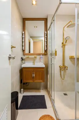 a bathroom with a sink and a shower at Opulent Condo Knightsbridge Residences in Manila
