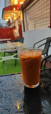 a drink sitting on top of a table at Thai Nee Homestay in Manila