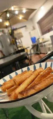 a plate of french fries on a table at Thai Nee Homestay in Manila