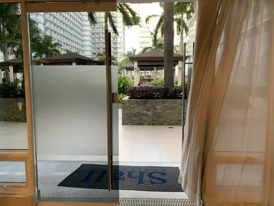 an open door to a building with a sign on it at Shell Residence MOA Pasay by Kathy in Manila