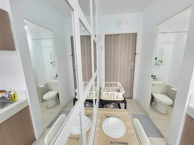 a white bathroom with two toilets and a sink at Erro Place Wi-Fi 200mbps & Netflix in Manila