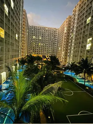 a view of a hotel with palm trees and buildings at Shore 1br shortwalk mall of asia in Manila