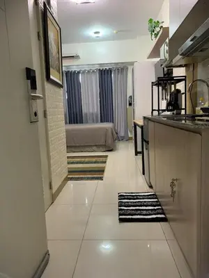 a hallway of a room with a kitchen and a bedroom at Comfy Studio near Southmall Las Piñas in Manila