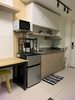 a kitchen with a sink and a microwave at Comfy Studio near Southmall Las Piñas in Manila