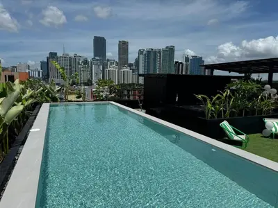 a swimming pool on top of a building with a city skyline at Canopyproperties in Manila