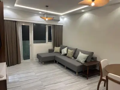 a living room with a couch and a table at Cozy Modern Apartment with Luxury Amenities in Manila