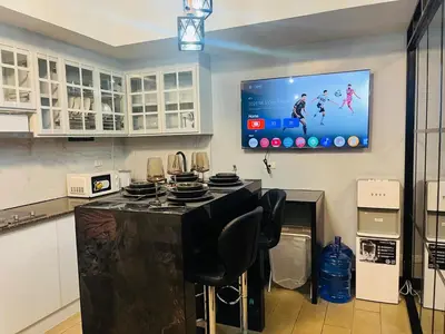 a kitchen with a tv hanging on the wall at Venice Luxury Residences Grand Canal View- Tower E in Manila