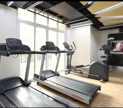a gym with two treadmills on a treadmill at Venice Luxury Residences Grand Canal View- Tower E in Manila