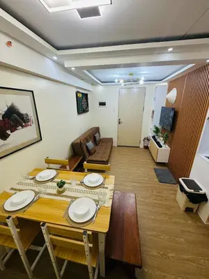 a dining room with a table with plates on it at 17th Casa Horizon in Manila
