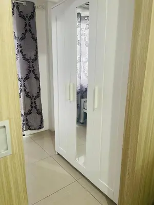 a door with a mirror in a room at 1 bedroom near MOA NAIA with parking slot included pls send valid ids of guests after booking in Manila