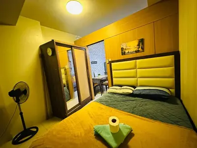 a bedroom with a bed with a roll of toilet paper on it at Simple Pasay Getaway - Entire Apartment for Rent in Manila