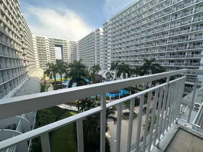 a view from the balcony of a large apartment building at Charming 1-Bedroom Apartment in the Heart of Pasay City in Manila