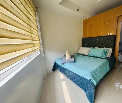 a small bed in a room with a window at Ultra Pasay City Apartment for Rent - Perfect for Short-Term Stay Front of MOA in Manila