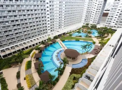 an aerial view of a large building with a swimming pool at Timeless Pasay City Apartment for Rent in Manila