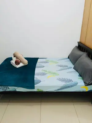 a bed with a blanket and a towel on it at Gentle Pasay City Apartment for Rent - Perfect Family Getaway Near Mall of Asia in Manila