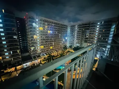 a view of a city at night with tall buildings at Happy 1br Pasay Apartment for Rent -Peaceful Oasis in the City near Mall Of Asia in Manila