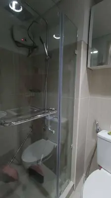 a glass shower in a bathroom with a toilet at Yare Pasay City Apartment for Rent Perfect for Stay front of Mall of Asia in Manila