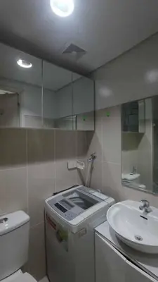 a bathroom with a sink and a toilet and a mirror at Yare Pasay City Apartment for Rent Perfect for Stay front of Mall of Asia in Manila