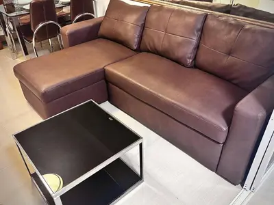 a brown couch with a black box in a living room at Yare Pasay City Apartment for Rent Perfect for Stay front of Mall of Asia in Manila