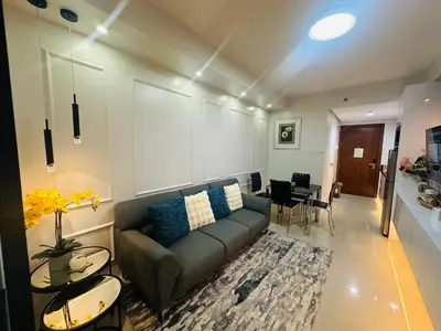 a living room with a couch and a table at Chic Retreat in Pasay City - Scandinavian with Balcony facing Mall Of Asia in Manila